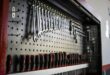 A collection of hand tools neatly arranged on a pegboard for easy access and organization.