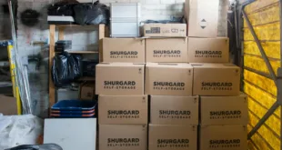 A stack of storage boxes in a well-organized warehouse interior.
