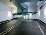 Interior view of a modern underground parking garage in Berlin, Germany. Well-lit and empty passage.