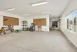 A bright and spacious industrial workshop with machinery and tools.