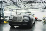 Sleek Rolls-Royce showcased in a contemporary garage with unique lighting design.