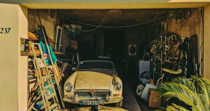 Classic convertible parked in a cluttered garage, Dobrota, Montenegro.