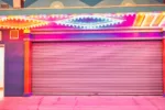 A brightly colored garage door illuminated by vivid neon lights in a retro style setting.